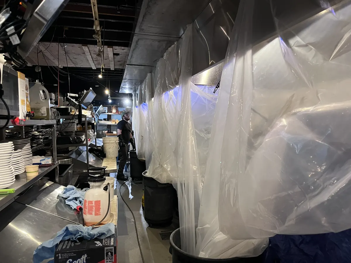 Cook line covered in plastic during hood cleaning